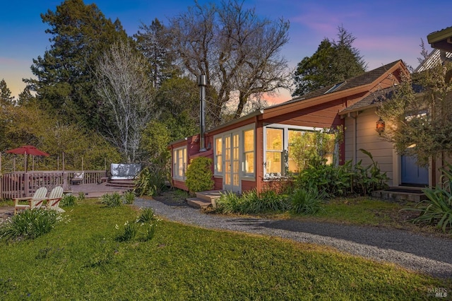 view of side of property with a yard