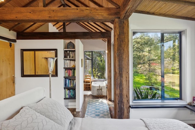 bedroom with multiple windows, wood finished floors, wooden ceiling, and lofted ceiling with beams