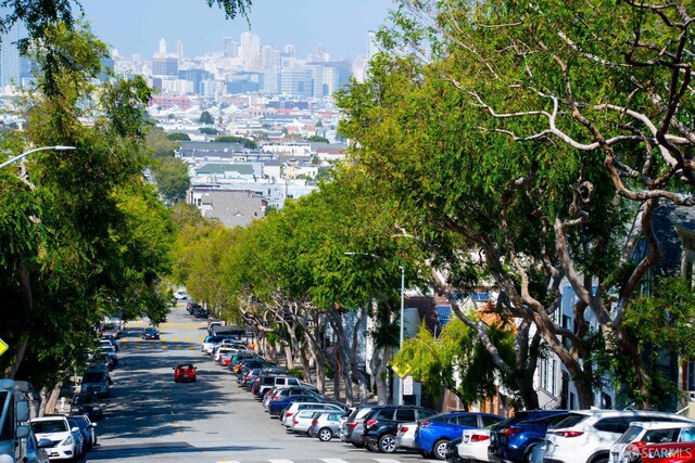 569 Peralta Ave, San Francisco, CA 94110 - view of asphalt street with a view of skyline and street lighting