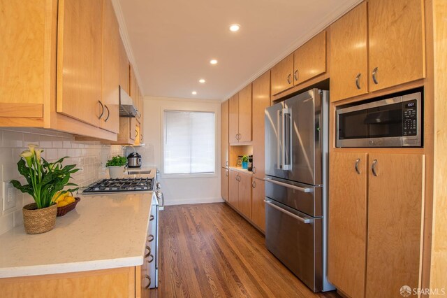 569 Peralta Ave, San Francisco, CA 94110 - kitchen with stainless steel appliances, ornamental molding, wood finished floors, decorative backsplash, and baseboards