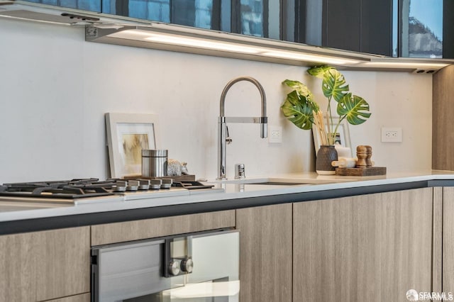 interior space with stainless steel gas stovetop and light brown cabinets