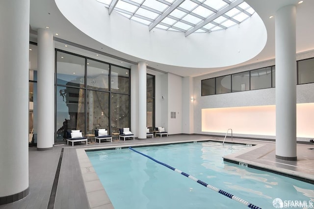 view of swimming pool featuring a skylight