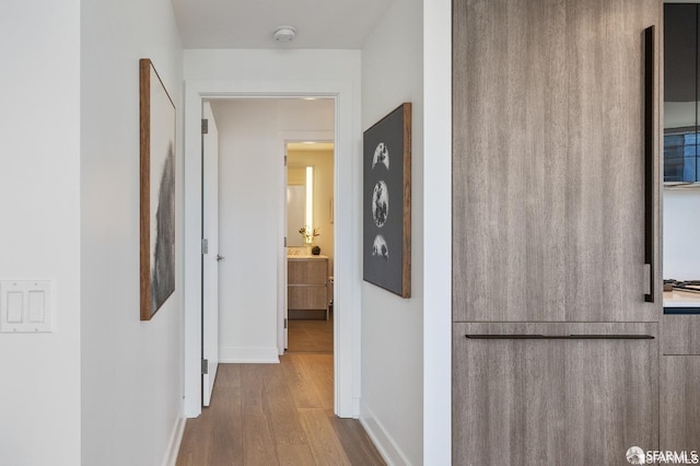 corridor with light hardwood / wood-style floors