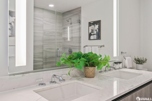 bathroom with vanity and a shower with shower door