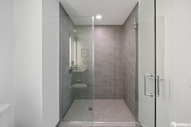 bathroom featuring walk in shower, toilet, and tile patterned floors