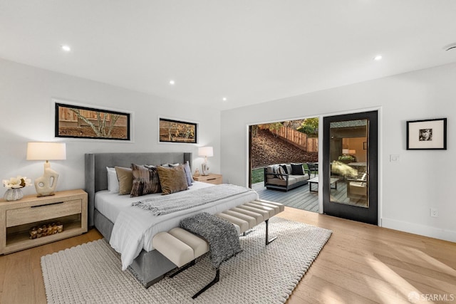 bedroom featuring access to outside and light hardwood / wood-style floors