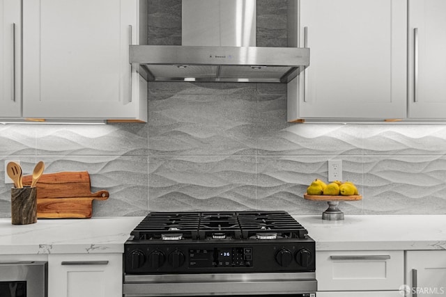 kitchen featuring white cabinetry, gas range, and wall chimney exhaust hood