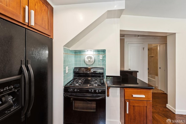 1375 Sacramento St, San Francisco, CA 94109 - kitchen featuring black appliances, brown cabinetry, dark countertops, and a peninsula