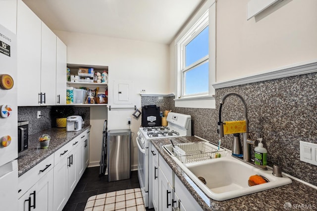 1375 Sacramento St, San Francisco, CA 94109 - kitchen with white gas stove, a sink, and white cabinetry