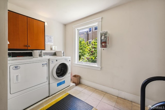1375 Sacramento St, San Francisco, CA 94109 - washroom featuring washer and dryer, light tile patterned floors, cabinet space, and baseboards
