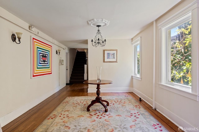 1375 Sacramento St, San Francisco, CA 94109 - unfurnished dining area featuring wood finished floors, stairs, a chandelier, and baseboards