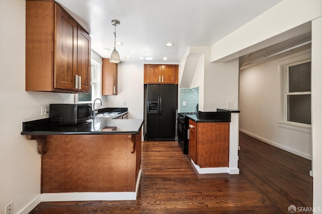 1375 Sacramento St, San Francisco, CA 94109 - kitchen featuring black appliances, a peninsula, wall chimney range hood, a sink, and dark countertops