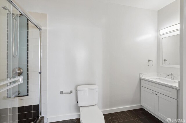 1375 Sacramento St, San Francisco, CA 94109 - bathroom with baseboards, vanity, a shower stall, toilet, and marble finish flooring