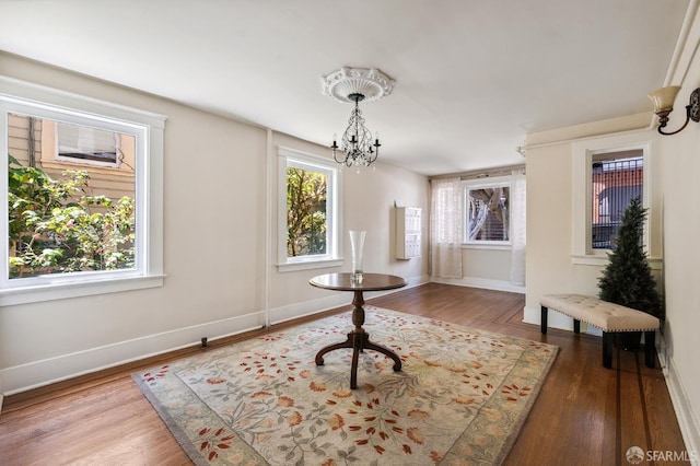 1375 Sacramento St, San Francisco, CA 94109 - unfurnished dining area with a chandelier, wood finished floors, and baseboards