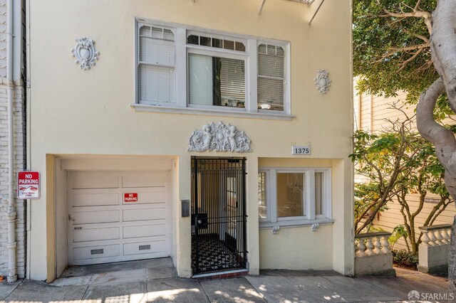 1375 Sacramento St, San Francisco, CA 94109 - property entrance with stucco siding and a garage