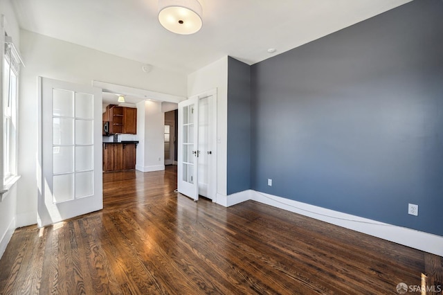 1375 Sacramento St, San Francisco, CA 94109 - spare room featuring french doors, baseboards, and dark wood-style flooring