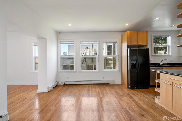 1375 Sacramento St, San Francisco, CA 94109 - kitchen with black fridge, open shelves, a baseboard heating unit, dark countertops, and recessed lighting