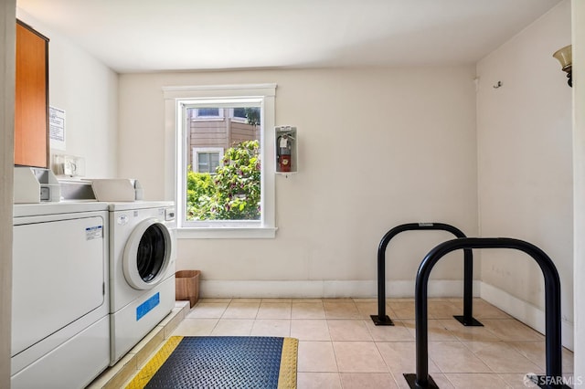 1375 Sacramento St, San Francisco, CA 94109 - laundry area with washing machine and dryer, baseboards, and light tile patterned flooring
