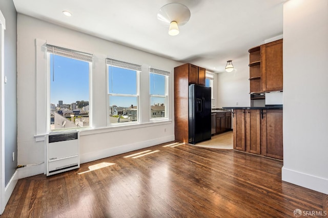 1375 Sacramento St, San Francisco, CA 94109 - kitchen featuring black refrigerator with ice dispenser, open shelves, and baseboards