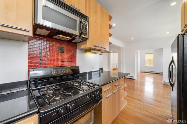 1375 Sacramento St, San Francisco, CA 94109 - kitchen featuring black appliances, light wood-style flooring, decorative backsplash, dark countertops, and a baseboard heating unit