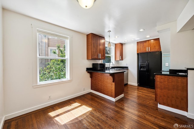 1375 Sacramento St, San Francisco, CA 94109 - kitchen featuring black refrigerator with ice dispenser, a peninsula, dark countertops, a sink, and brown cabinets