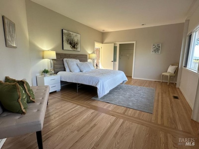 bedroom featuring a closet and light wood-type flooring