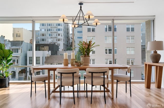 dining space featuring a chandelier and wood finished floors