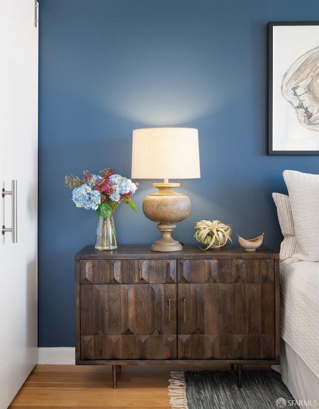 bedroom featuring baseboards and wood finished floors