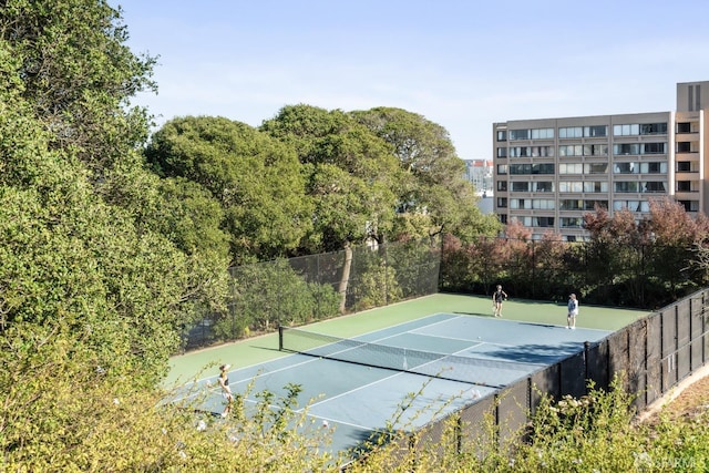 view of sport court featuring fence