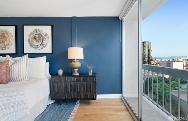 bedroom featuring wood finished floors and baseboards