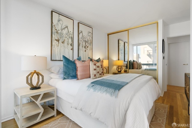 bedroom featuring a closet and wood finished floors