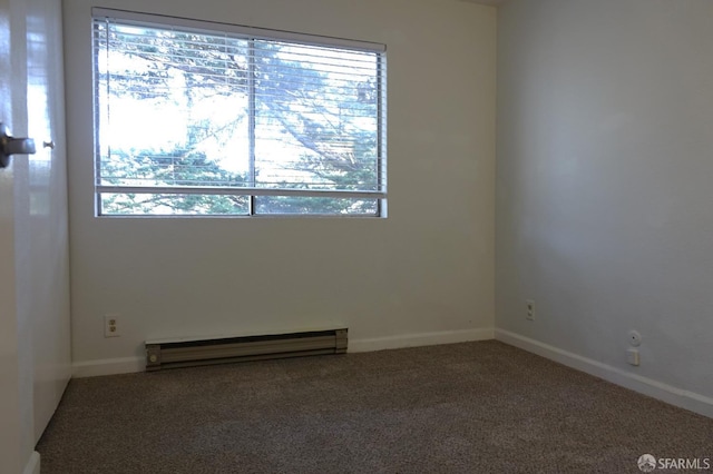 spare room featuring a wealth of natural light, carpet floors, and baseboard heating