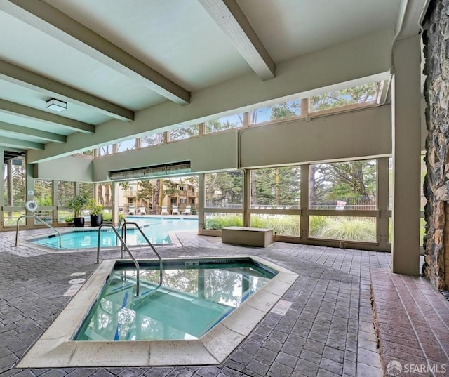 view of pool featuring a patio area and an indoor hot tub