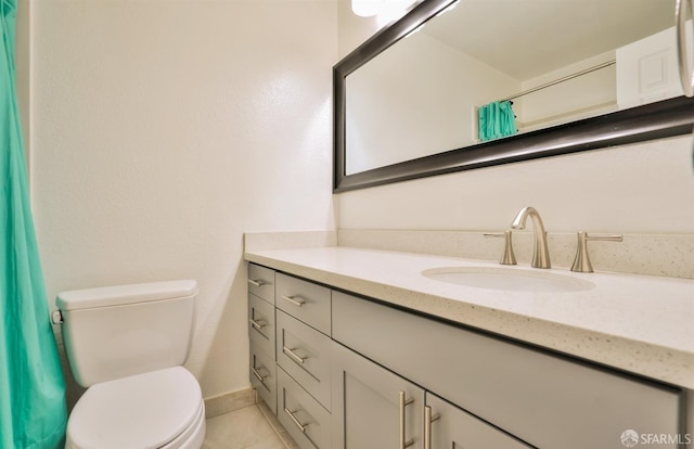 bathroom featuring vanity, toilet, curtained shower, and tile patterned flooring