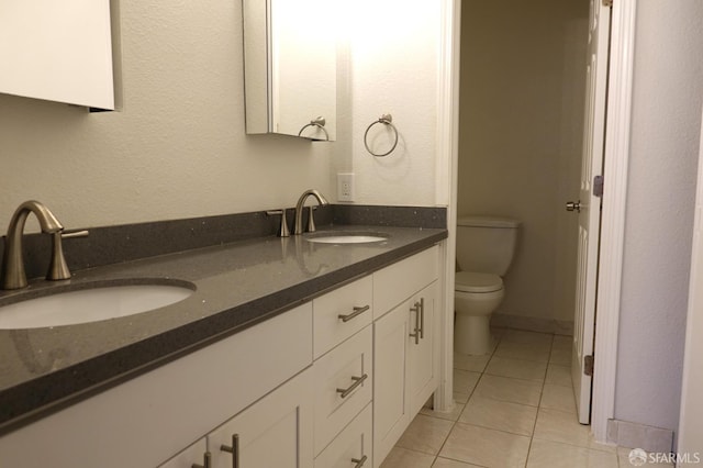 bathroom featuring vanity, toilet, and tile patterned flooring