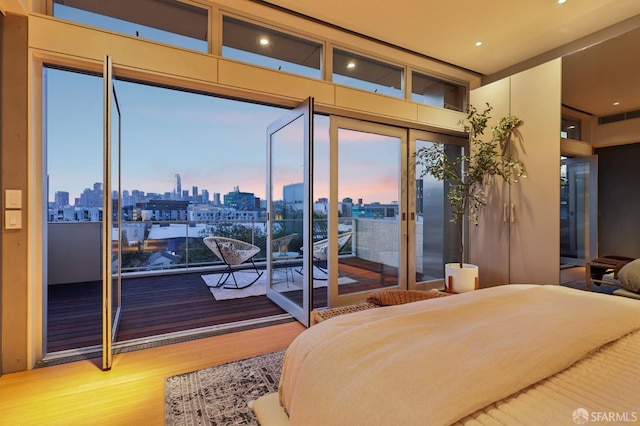 bedroom featuring access to outside and hardwood / wood-style floors