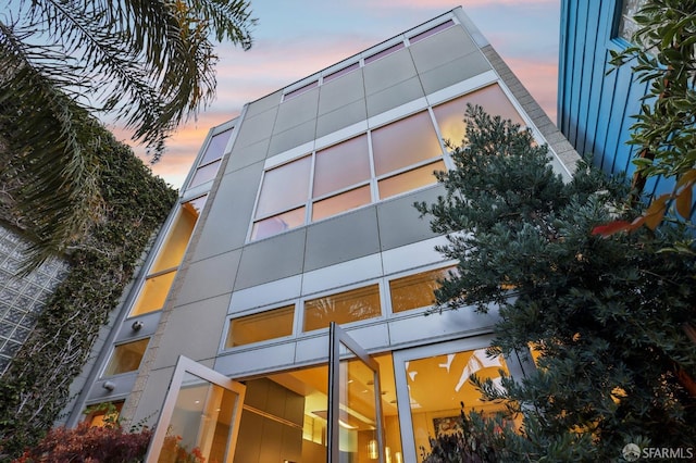 view of outdoor building at dusk