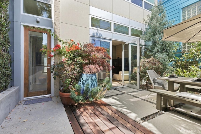 doorway to property with a deck and a patio area