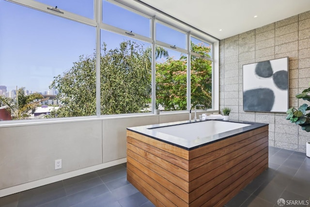 interior space featuring dark tile patterned floors and a wealth of natural light