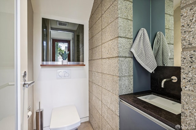 bathroom with vanity and toilet