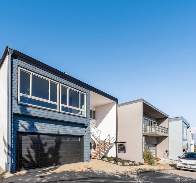 contemporary home featuring a garage and driveway