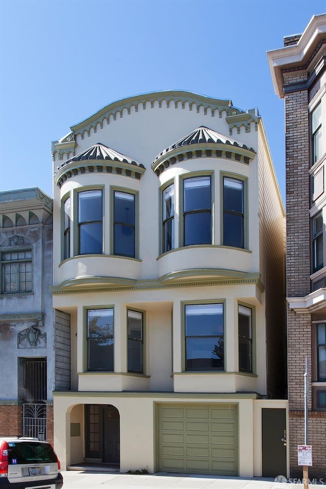 245 Scott St, San Francisco, CA 94117 - view of front of property with an attached garage, driveway, and stucco siding