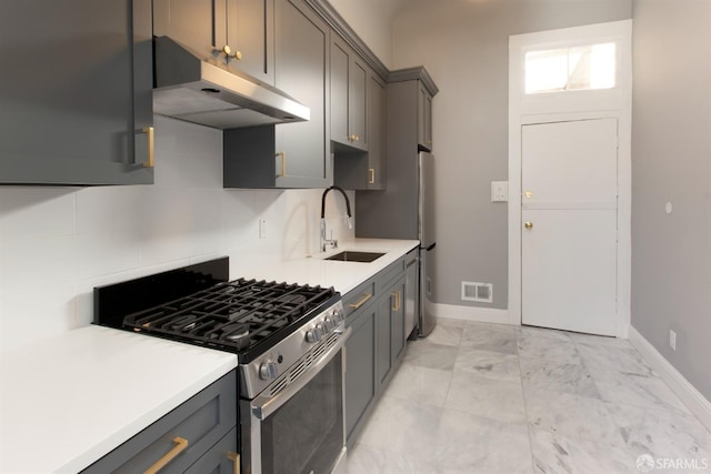 245 Scott St, San Francisco, CA 94117 - kitchen featuring visible vents, gray cabinets, under cabinet range hood, gas stove, and baseboards