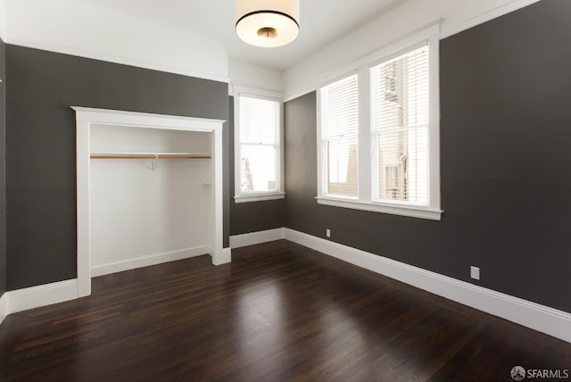 245 Scott St, San Francisco, CA 94117 - unfurnished bedroom with dark wood-style flooring, a closet, and baseboards