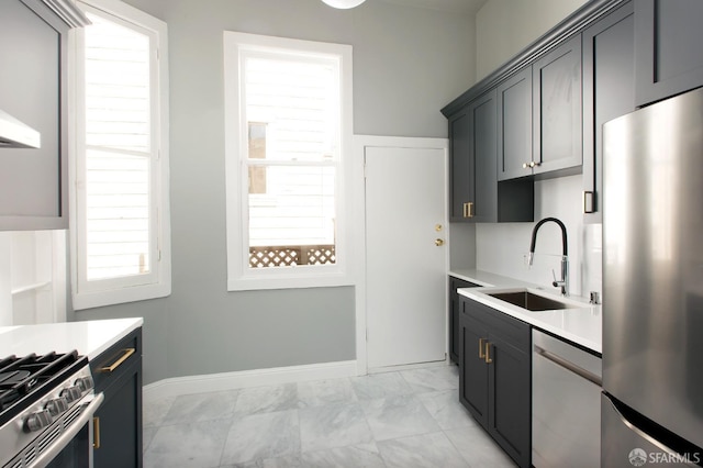 245 Scott St, San Francisco, CA 94117 - kitchen featuring marble finish floor, light countertops, a sink, stainless steel appliances, and baseboards