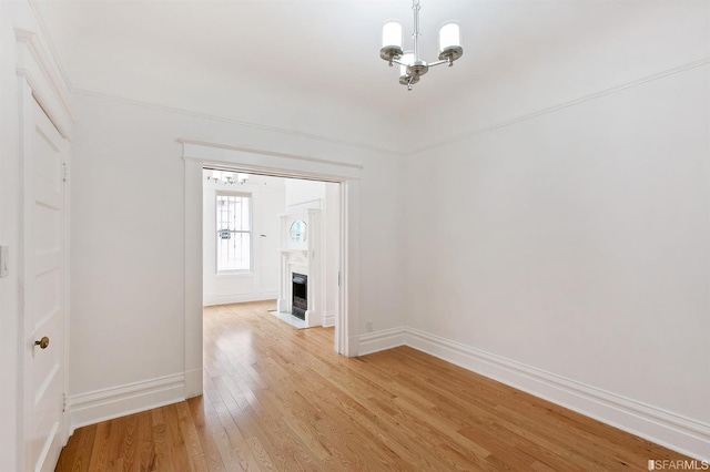 interior space with light hardwood / wood-style floors and a chandelier