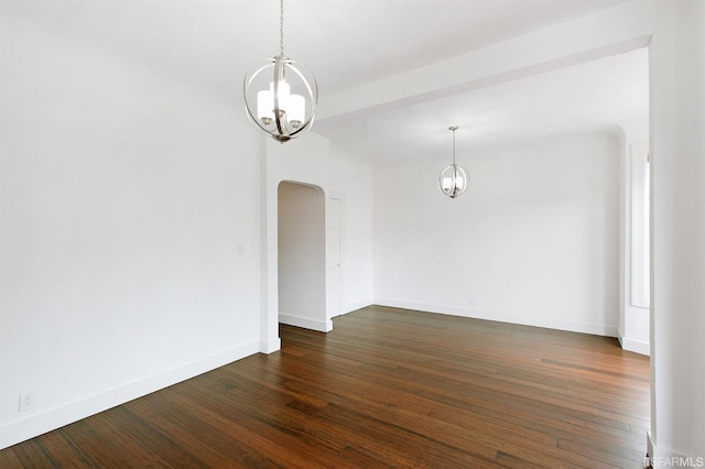 empty room featuring dark hardwood / wood-style floors and a chandelier