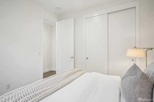 176 Summit Way, San Francisco, CA 94132 - bedroom featuring a closet, baseboards, and wood finished floors
