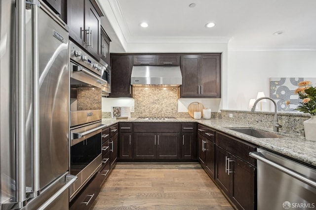 176 Summit Way, San Francisco, CA 94132 - kitchen with stainless steel appliances, a sink, range hood, light wood finished floors, and light stone countertops