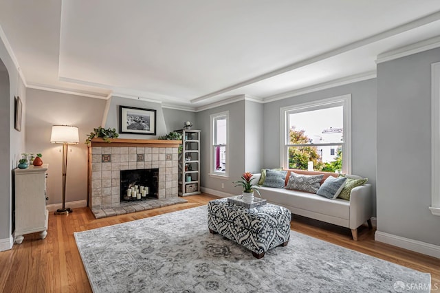 1655 24th Ave, San Francisco, CA 94122 - living room featuring a fireplace, wood finished floors, baseboards, a raised ceiling, and crown molding